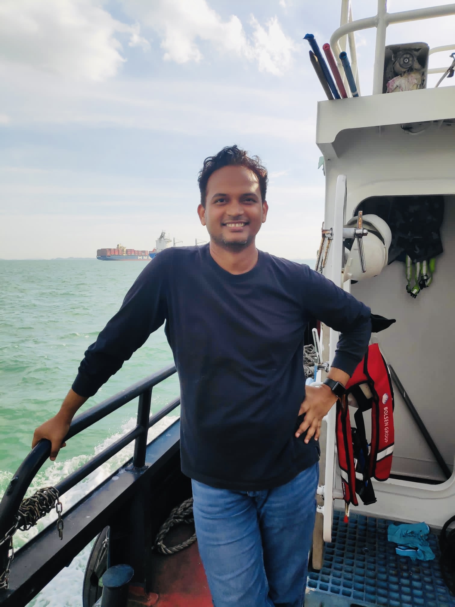 Prasad Anjangi aboard a vessel during marine field work in Singapore